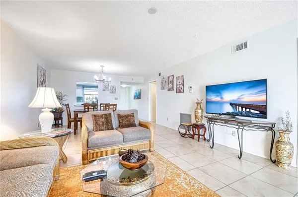 a living room with furniture a rug and a flat screen tv