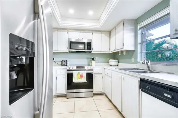 a kitchen with stainless steel appliances granite countertop a sink and cabinets