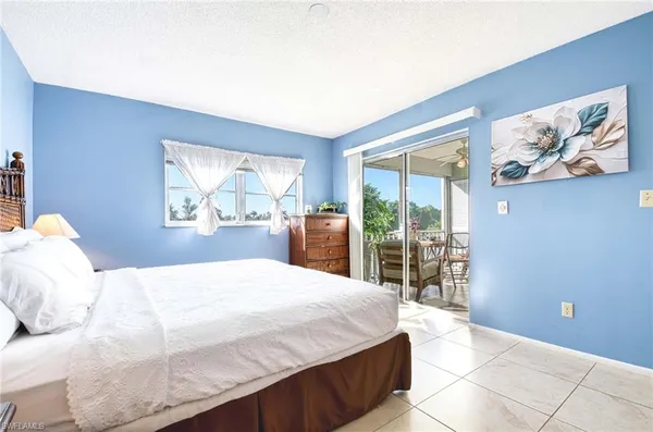 a bedroom with a large bed and a large window