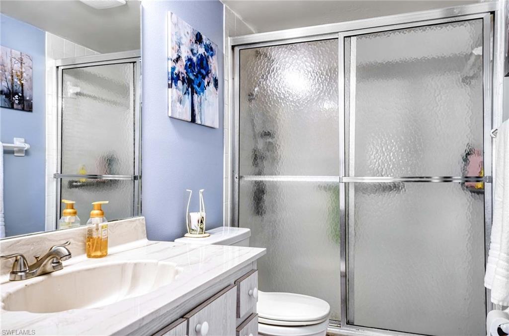 5483 Rattlesnake Hammock Road, Unit 207 Naples, FL 34113 - Photo 10 of 15 Full bath featuring vanity and a shower stall