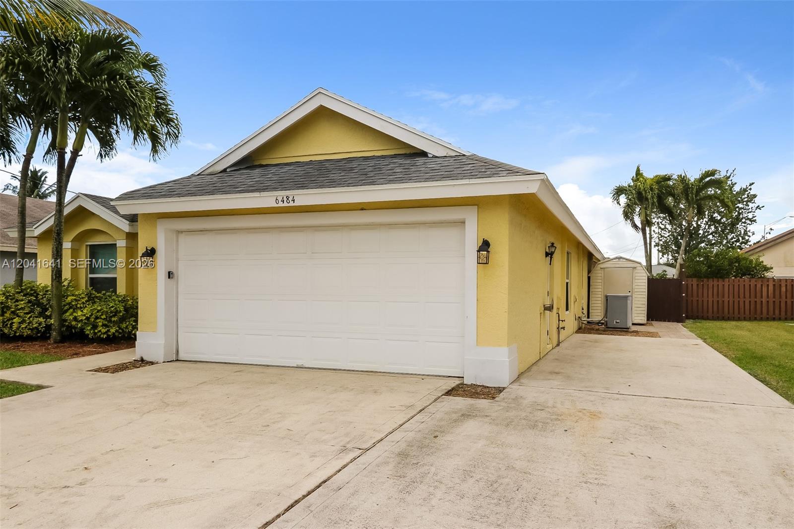 6484 Robinson Street Jupiter, FL 33458 - Photo 3 of 15 a front view of a house with a yard