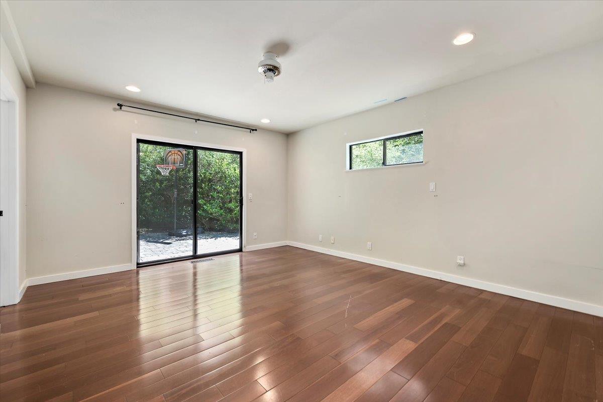 885 Patrol Road Woodside, CA 94062 - Photo 14 of 34 a view of an empty room with wooden floor and a window