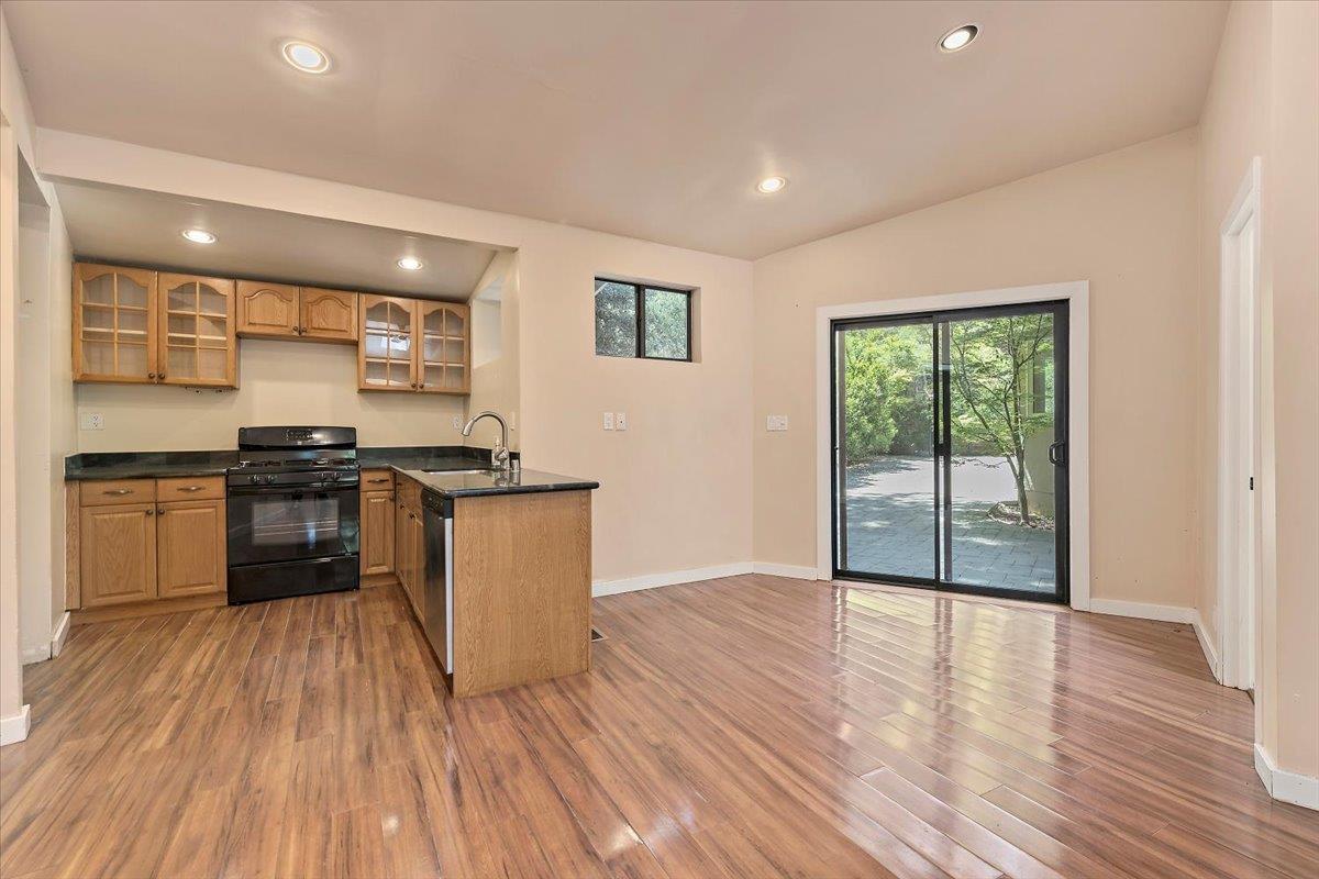 885 Patrol Road Woodside, CA 94062 - Photo 21 of 34 a kitchen with granite countertop wooden floors a stove and a refrigerator