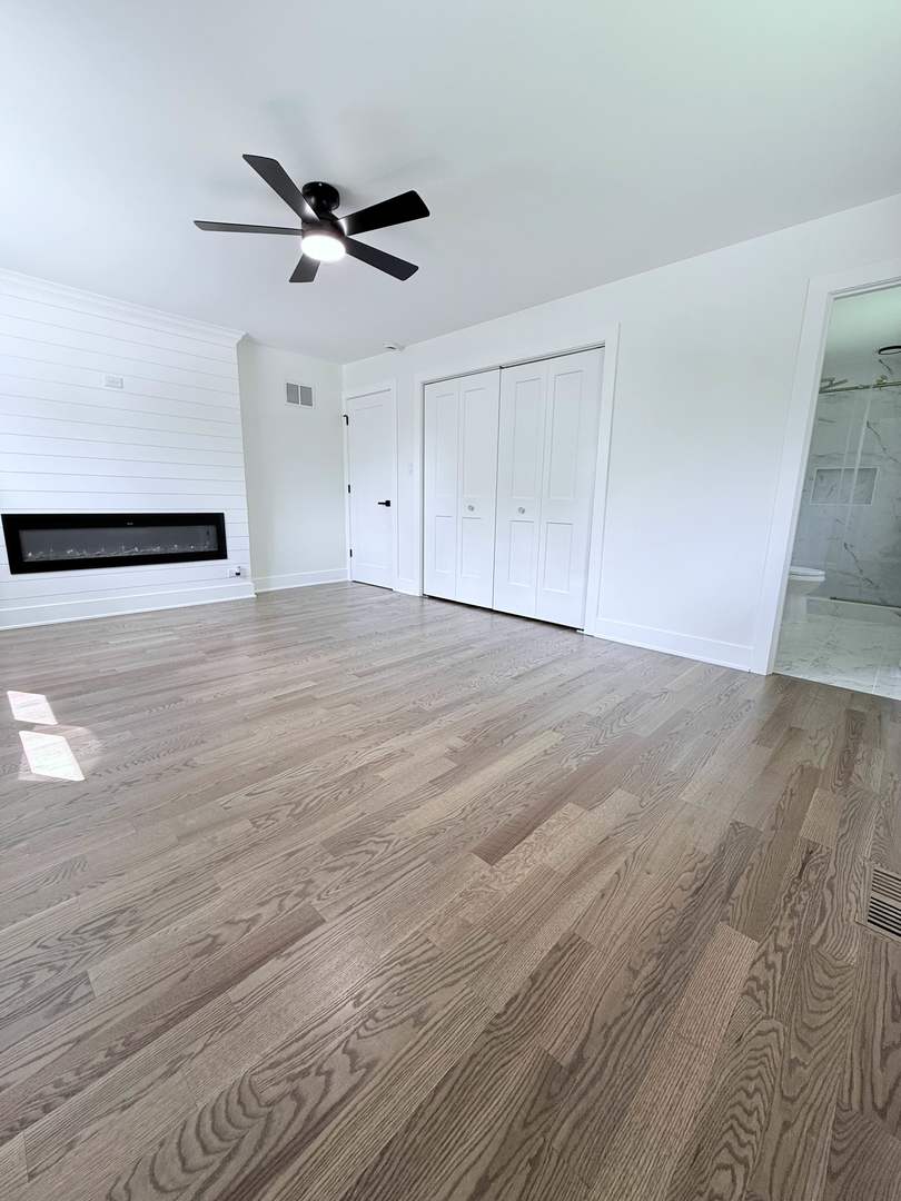 1581 Groton Lane Wheaton, IL 60189 - Photo 12 of 15 a view of empty room with wooden floor and ceiling fan