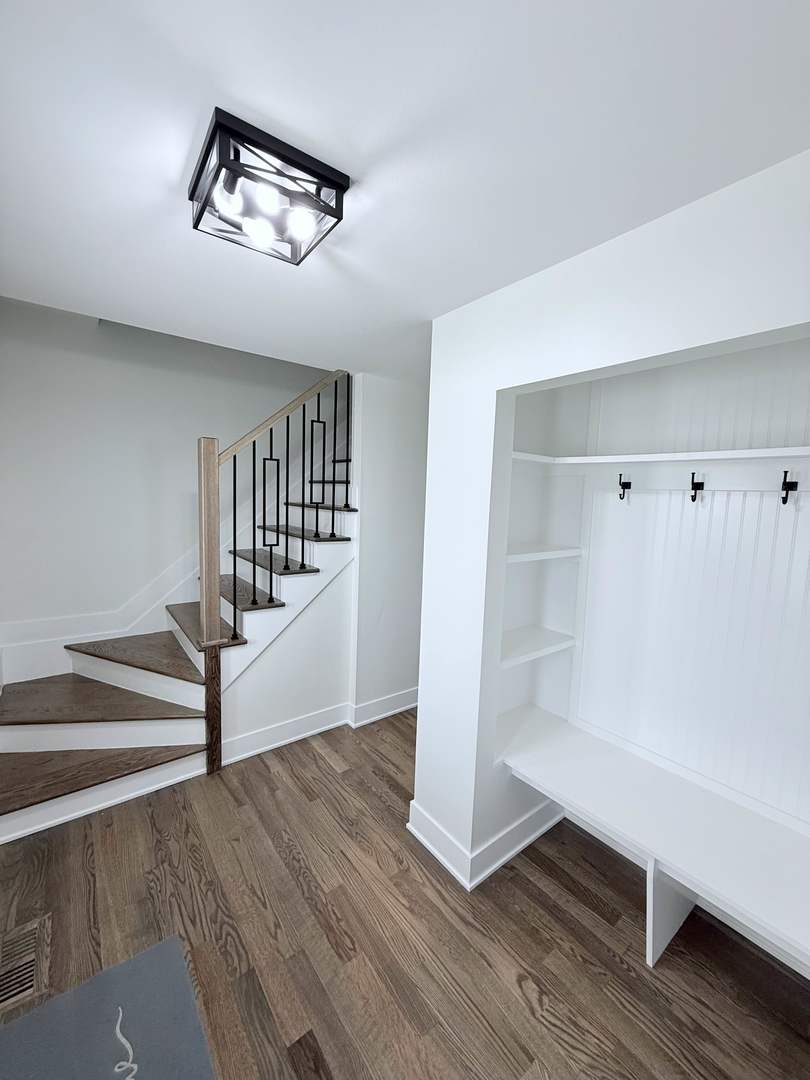 1581 Groton Lane Wheaton, IL 60189 - Photo 15 of 15 a view of a hallway with wooden floor and stairs