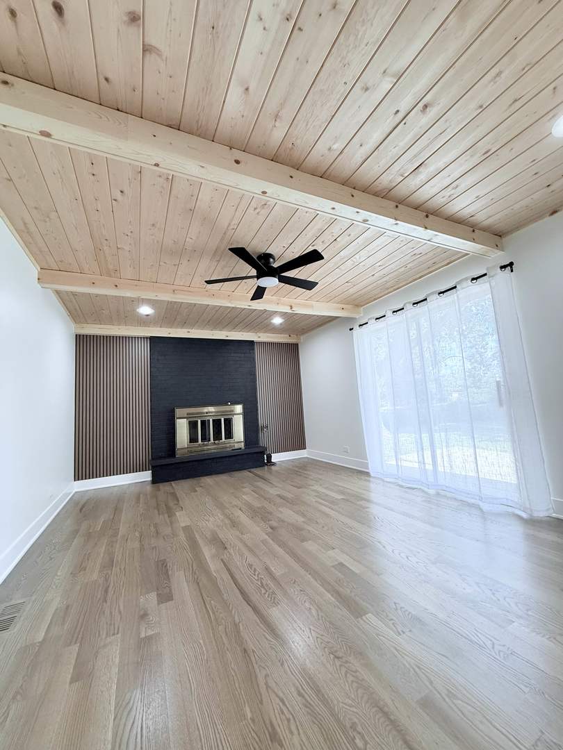 1581 Groton Lane Wheaton, IL 60189 - Photo 6 of 15 a view of an empty room with a fireplace