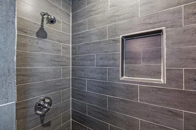 a bathroom with a shower and a window