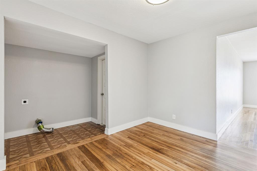3226 Inwood Road Dallas, TX 75235 - Photo 21 of 25 a view of a room with wooden floor and empty shelves