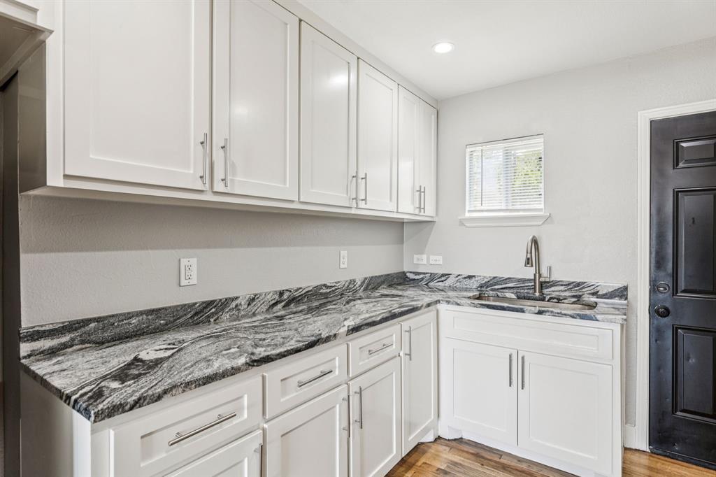3226 Inwood Road Dallas, TX 75235 - Photo 9 of 25 a kitchen with granite countertop a sink and cabinets