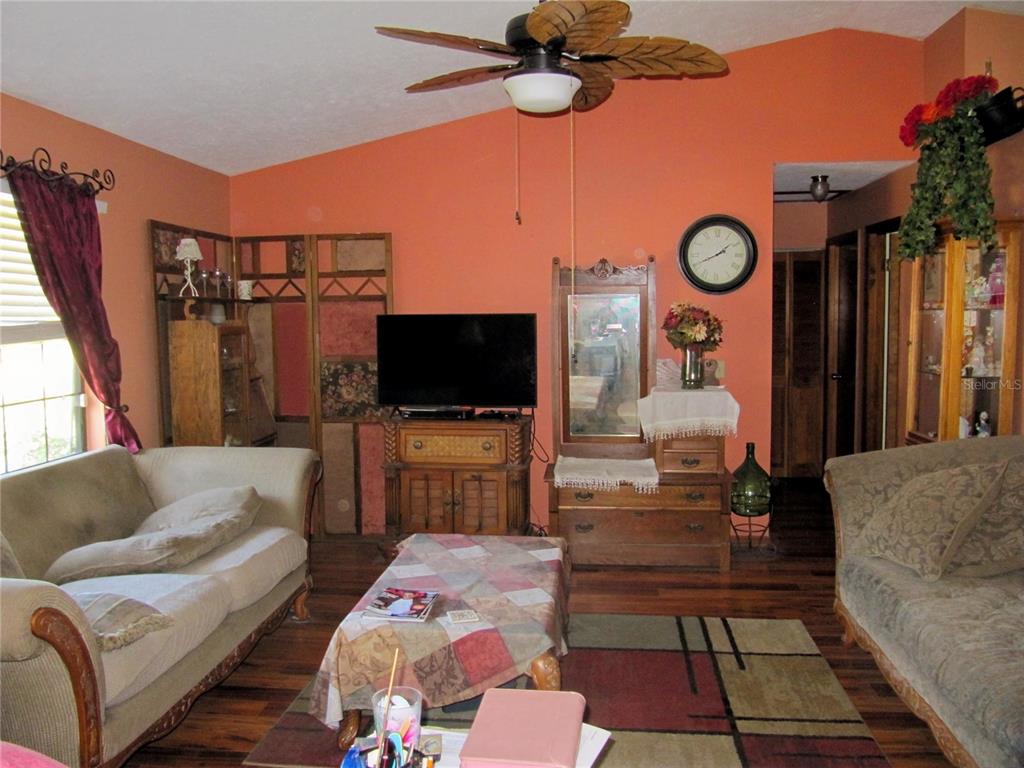 11815 Southeast 84 Avenue Belleview, FL 34420 - Photo 11 of 23 a living room with furniture and a flat screen tv