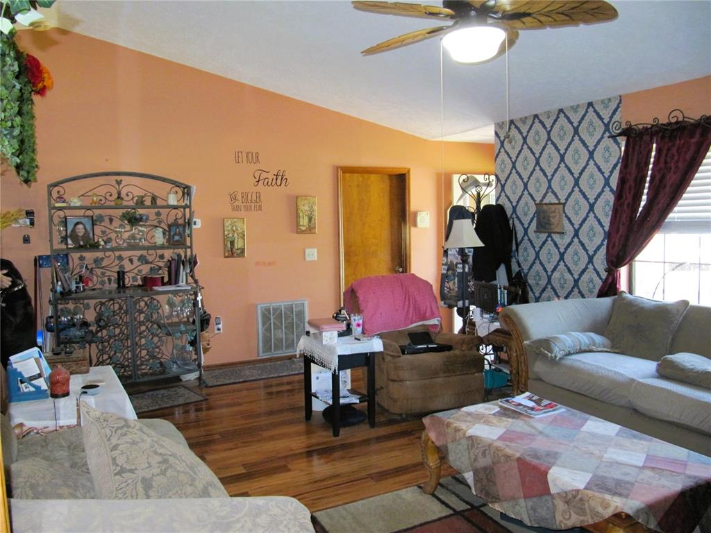 11815 Southeast 84 Avenue Belleview, FL 34420 - Photo 12 of 23 a living room with furniture and wooden floor