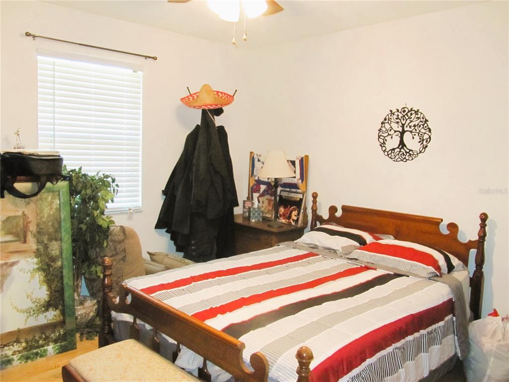 11815 Southeast 84 Avenue Belleview, FL 34420 - Photo 20 of 23 a bed sitting in a bedroom next to a window