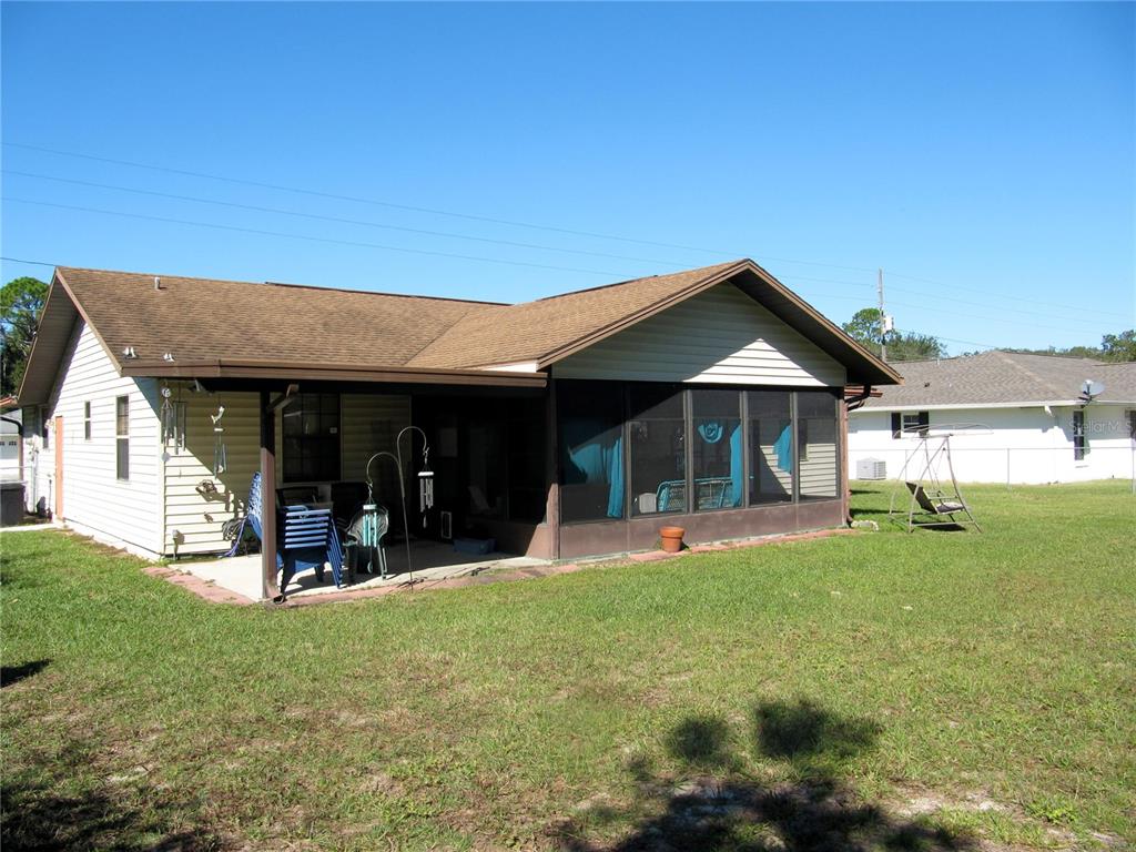 11815 Southeast 84 Avenue Belleview, FL 34420 - Photo 5 of 23 a view of a house with a yard patio and fire pit