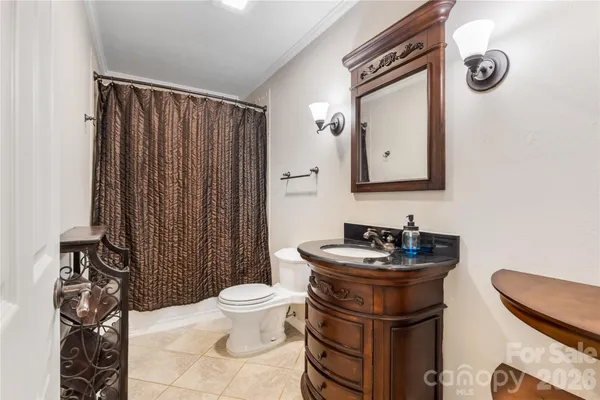 a bathroom with a sink toilet and mirror