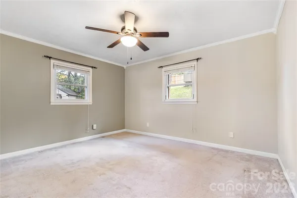 a view of room with window and ceiling fan