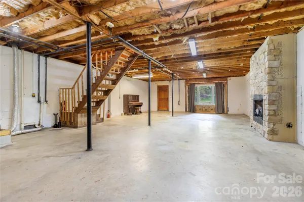 a view of a balcony with wooden floor next to a yard