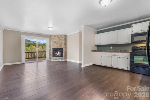 a kitchen with wooden floors and white cabinets