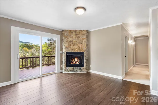 a view of a room window and wooden floor