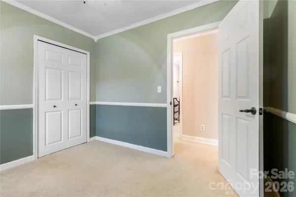 an empty room with closet and a flat screen tv