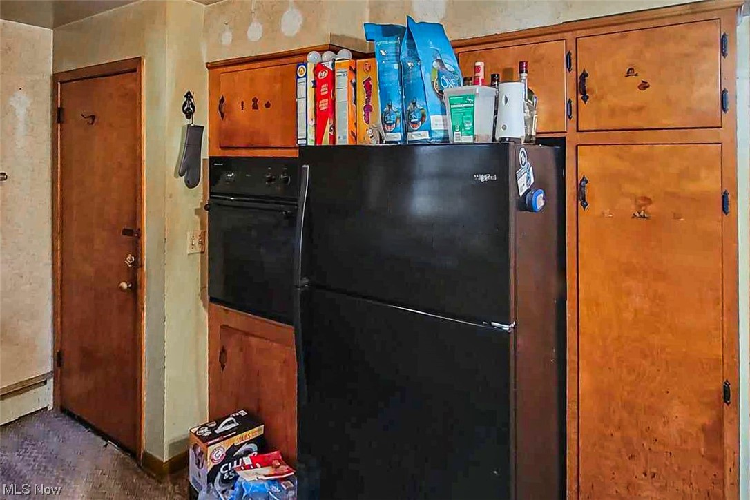 2677 Deibel Road Clinton, OH 44216 - Photo 13 of 16 Kitchen featuring a baseboard heating unit and black appliances