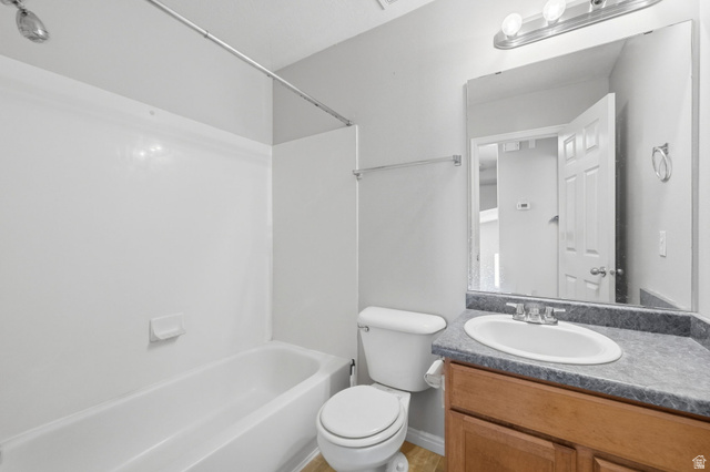 2575 Athena Drive Magna, UT 84044 - Photo 11 of 23 Bathroom featuring a single vanity with a laminate countertop, an undermount sink, and a wood-finish cabinet