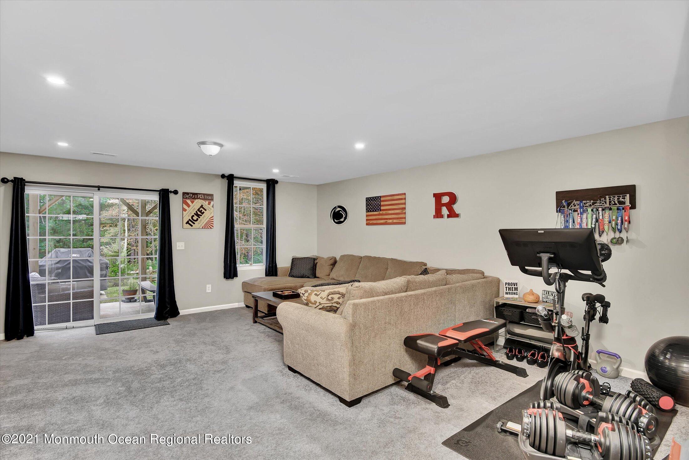 112 Revival Road, Unit 2012 Brick, NJ 08723 - Photo 11 of 22 a living room with furniture and a floor to ceiling window