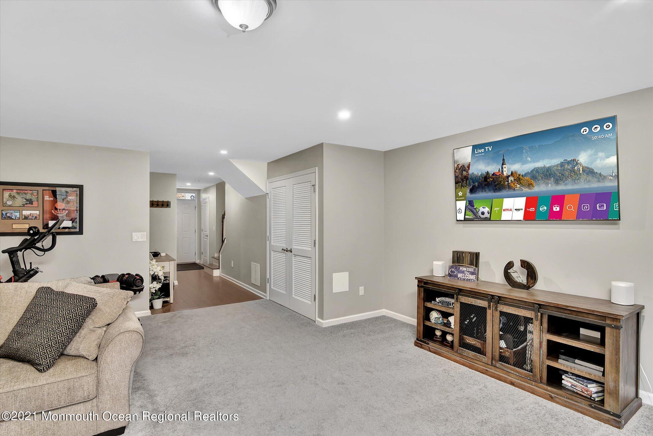 112 Revival Road, Unit 2012 Brick, NJ 08723 - Photo 12 of 22 a living room with furniture and a flat screen tv
