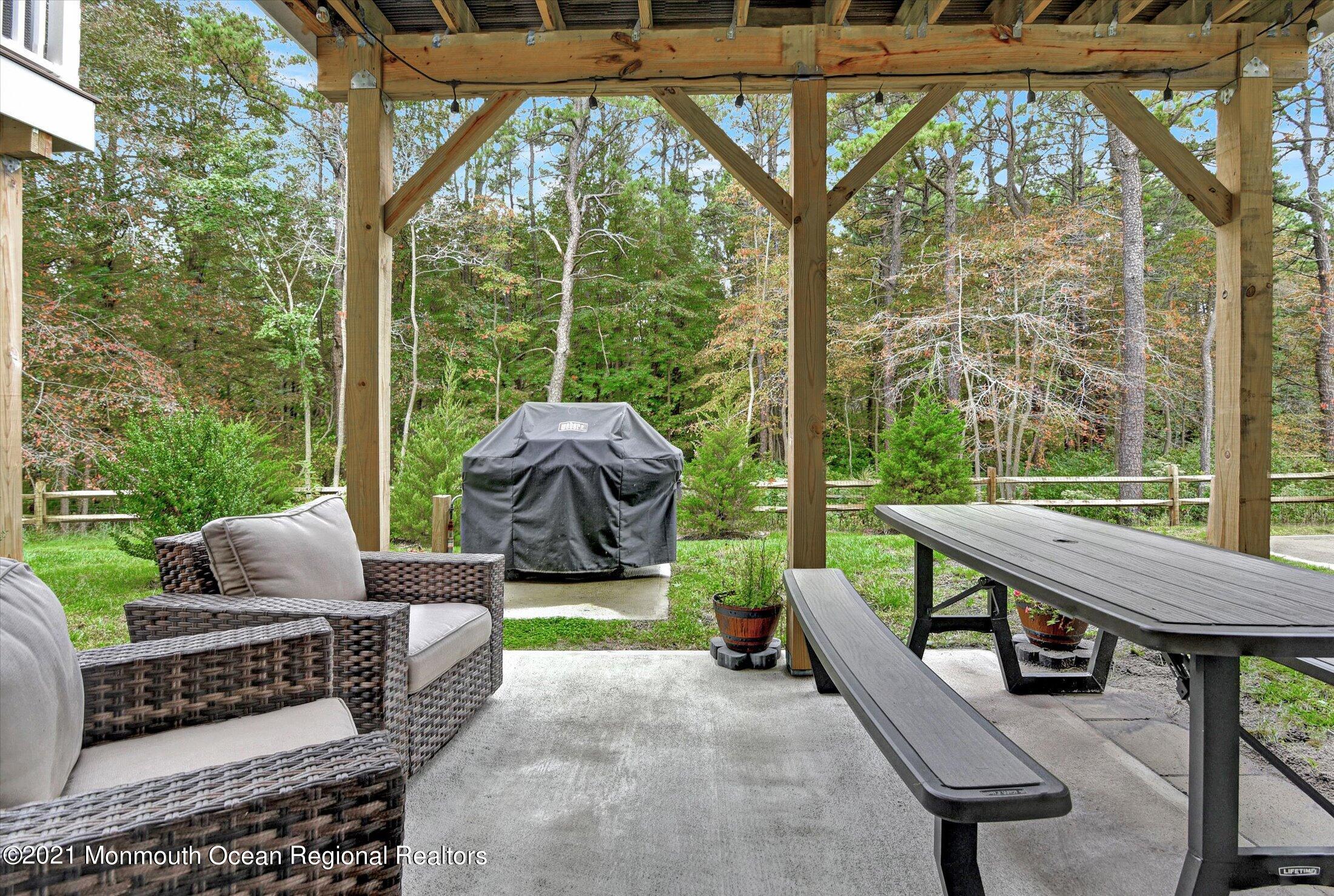 112 Revival Road, Unit 2012 Brick, NJ 08723 - Photo 13 of 22 a view of a patio with couches chairs and a table and chairs