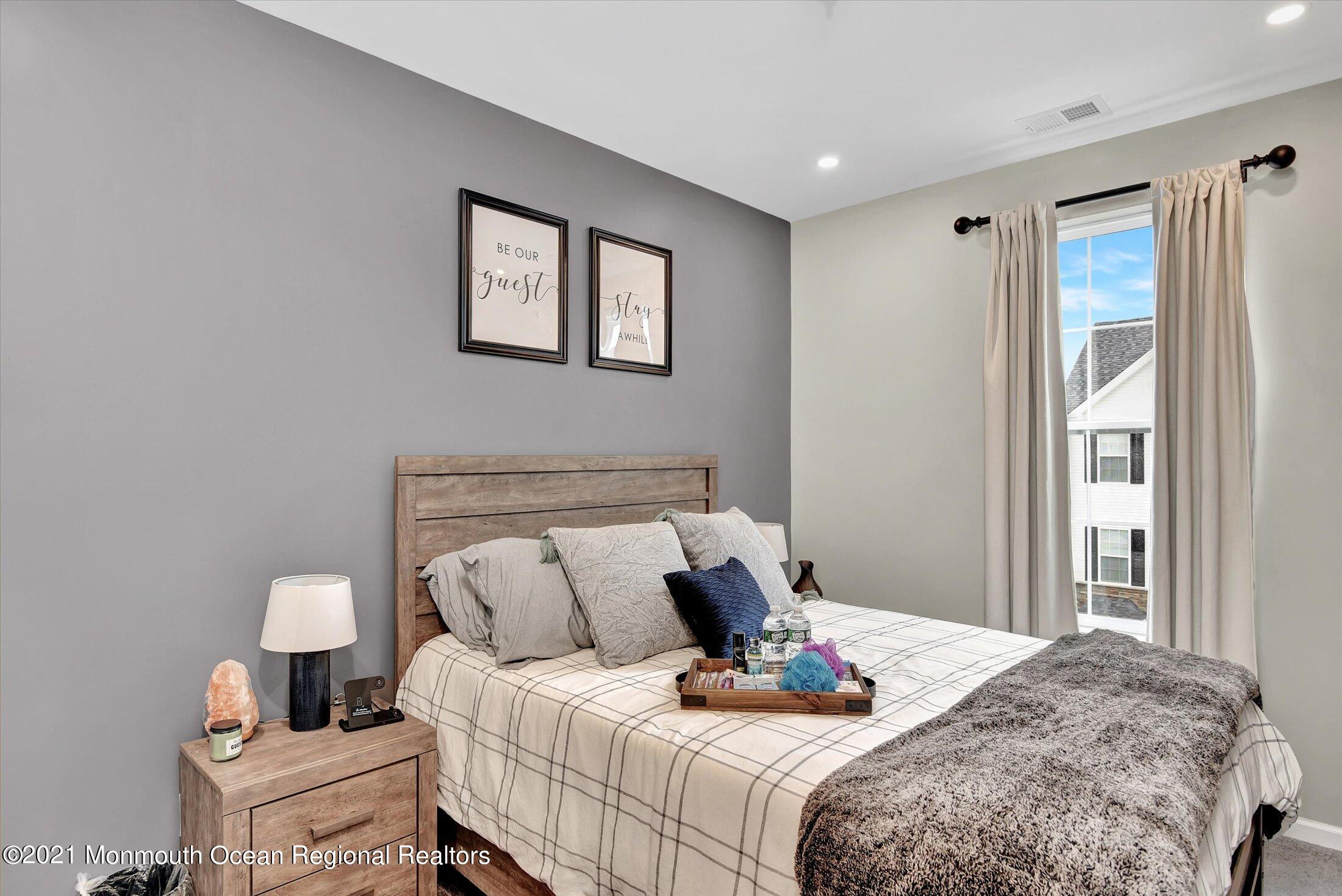 112 Revival Road, Unit 2012 Brick, NJ 08723 - Photo 20 of 22 a bedroom with a bed and wooden floor