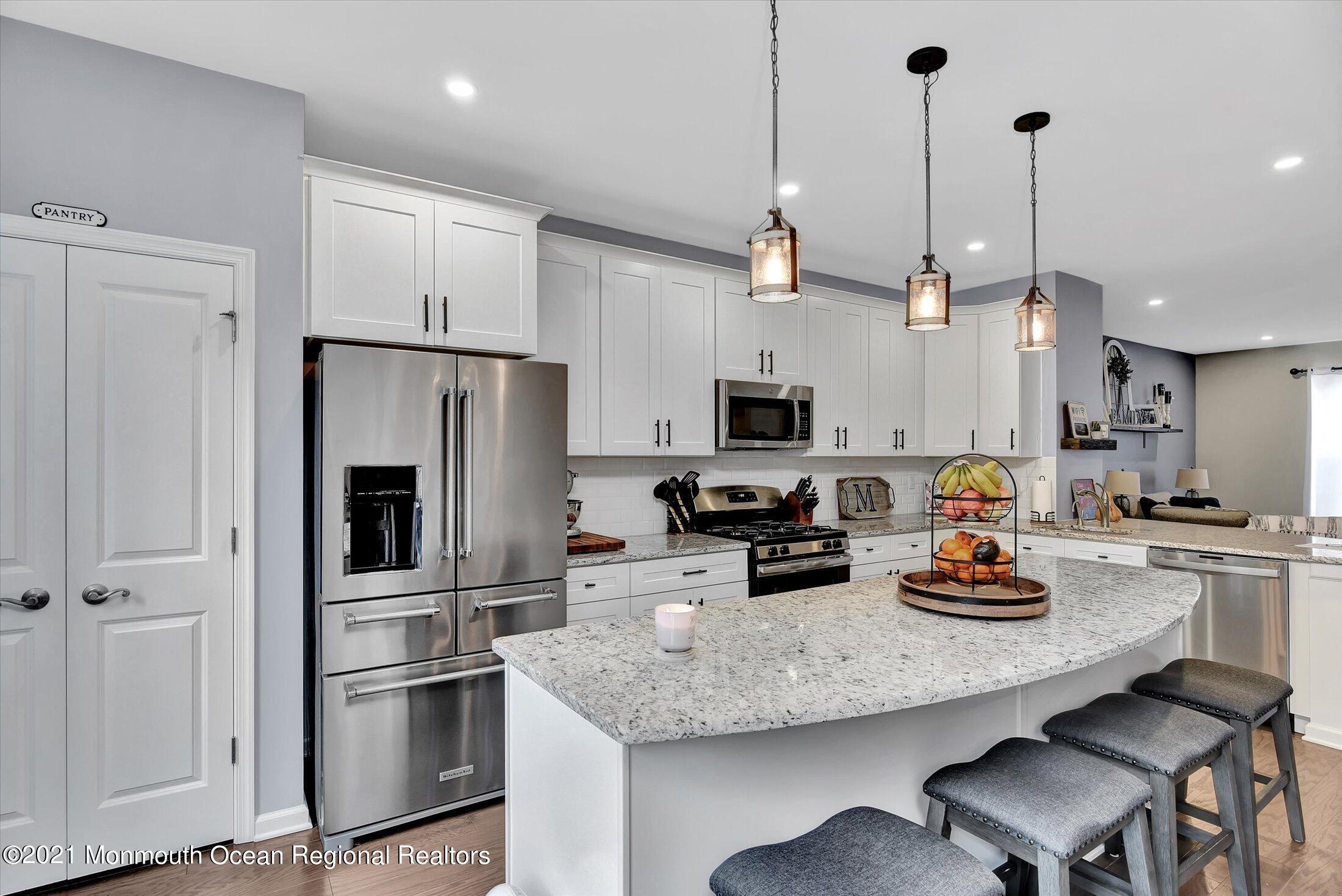 112 Revival Road, Unit 2012 Brick, NJ 08723 - Photo 3 of 22 a kitchen with stainless steel appliances granite countertop a sink refrigerator and microwave