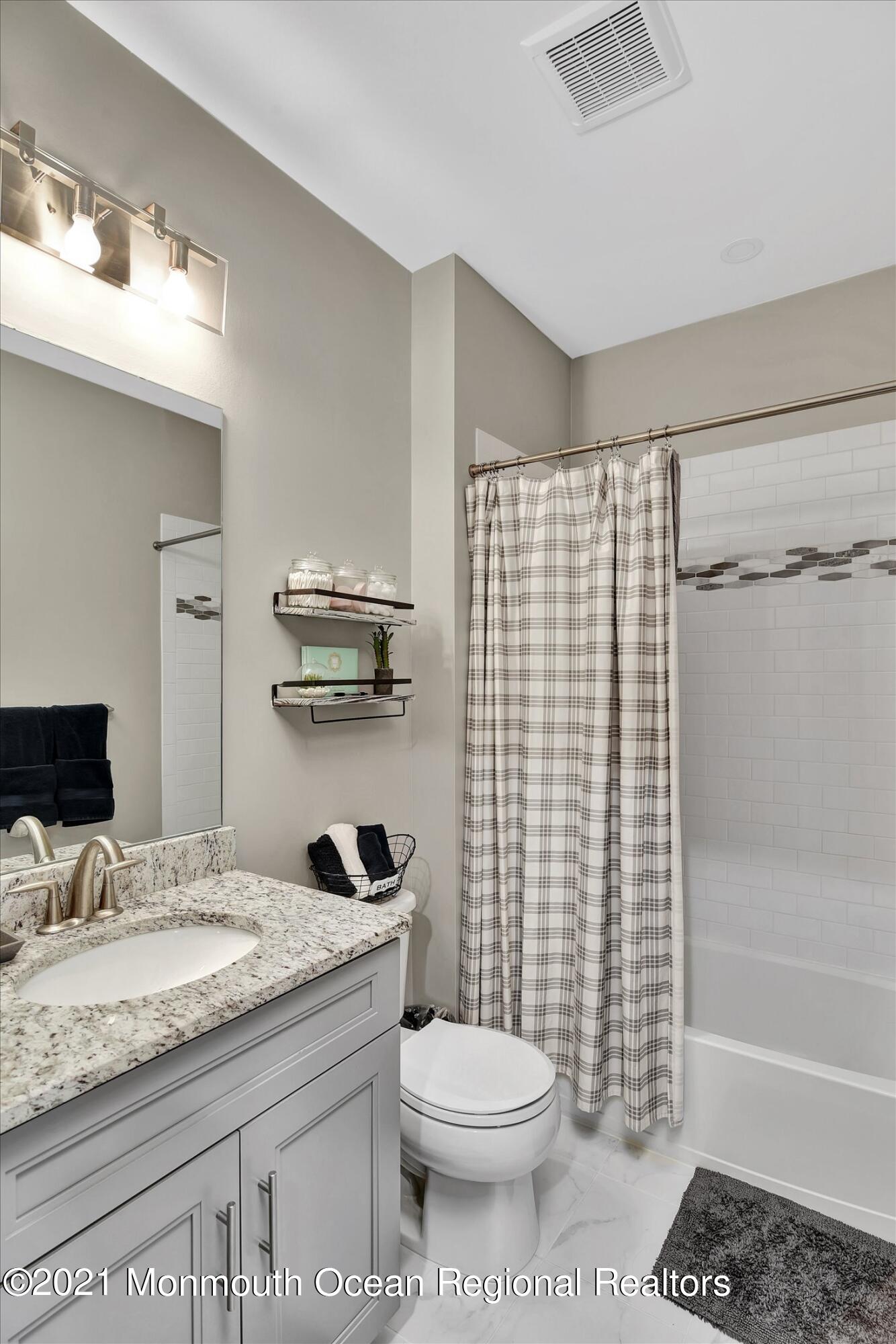 112 Revival Road, Unit 2012 Brick, NJ 08723 - Photo 21 of 22 a bathroom with a granite countertop toilet sink and shower
