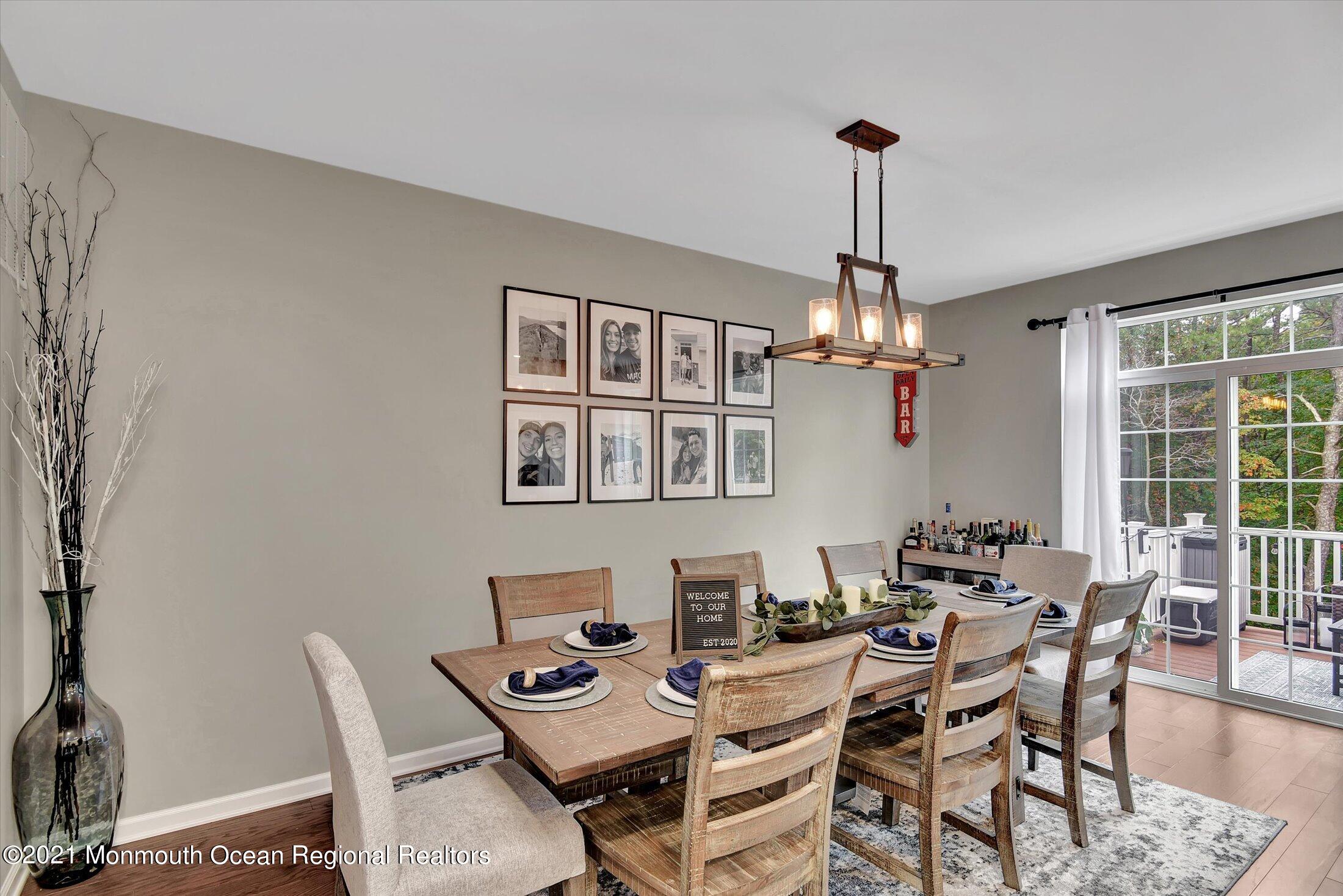 112 Revival Road, Unit 2012 Brick, NJ 08723 - Photo 4 of 22 a dining room with furniture a chandelier and window