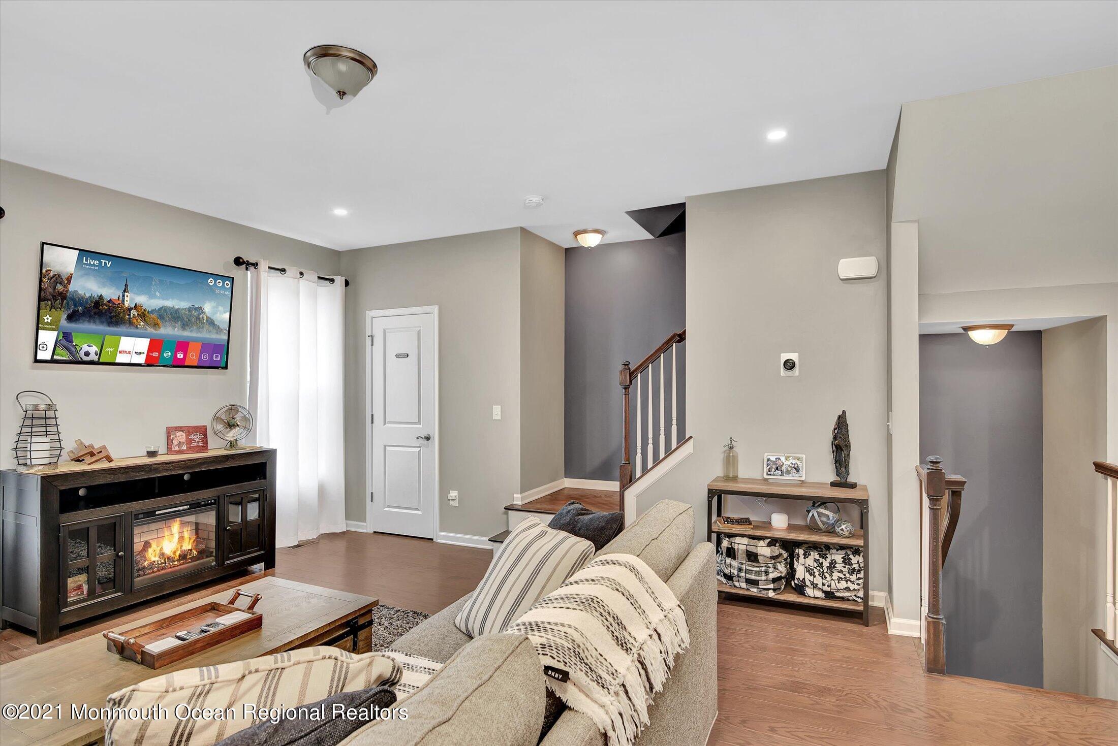 112 Revival Road, Unit 2012 Brick, NJ 08723 - Photo 8 of 22 a living room with furniture and a fireplace