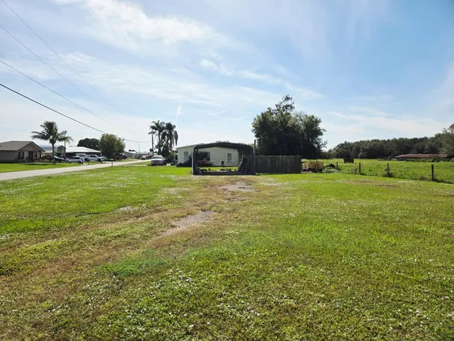 a view of a green field with clear sky