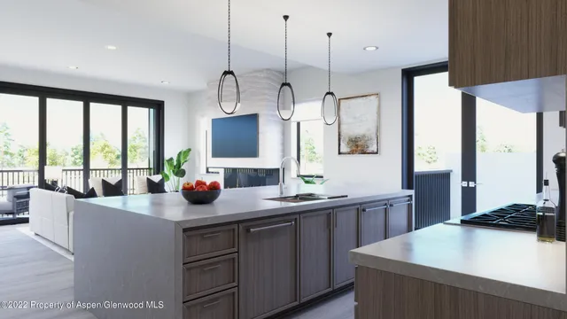 a kitchen with a sink a counter top space and living room view