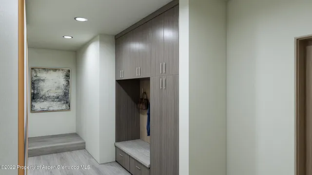 a view of a hallway with toilet and a refrigerator