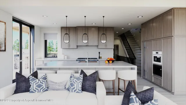 a kitchen with stainless steel appliances a table and chairs in it