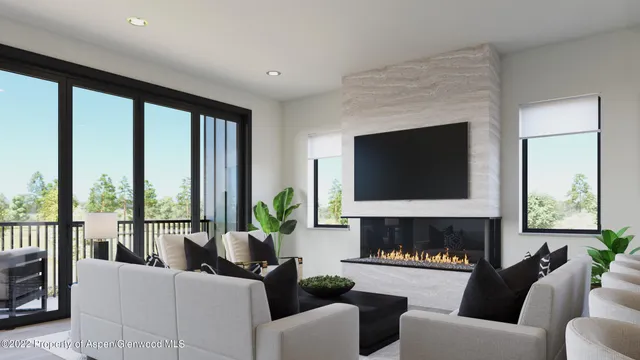 a living room with furniture a flat screen tv and a fireplace
