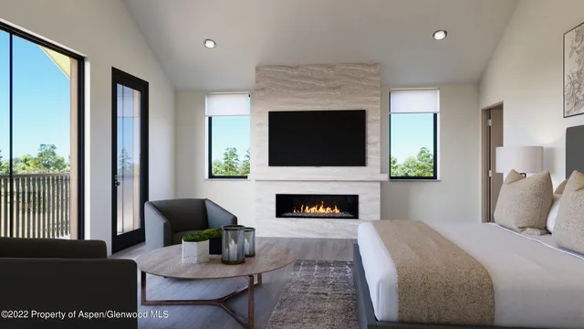 a bedroom with a bed a fireplace and a large window