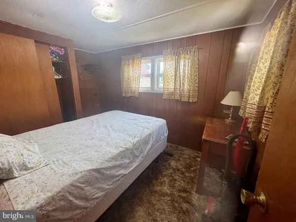 a bedroom with a bed and a mirror