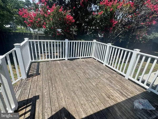 a view of backyard with deck and outdoor seating
