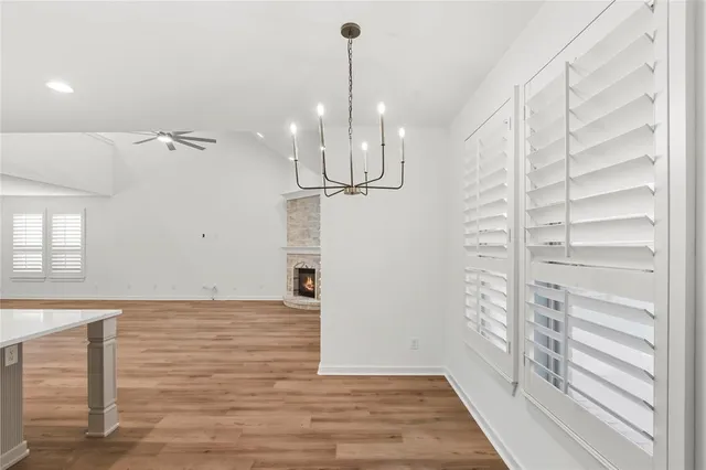 a view of a room with wooden floor and windows