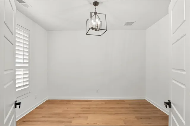a view of a room with wooden floor and windows