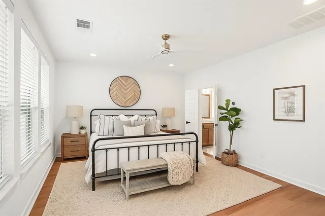 a view of a bedroom with furniture and a large window