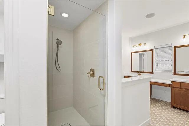 a bathroom with a shower sink and mirror