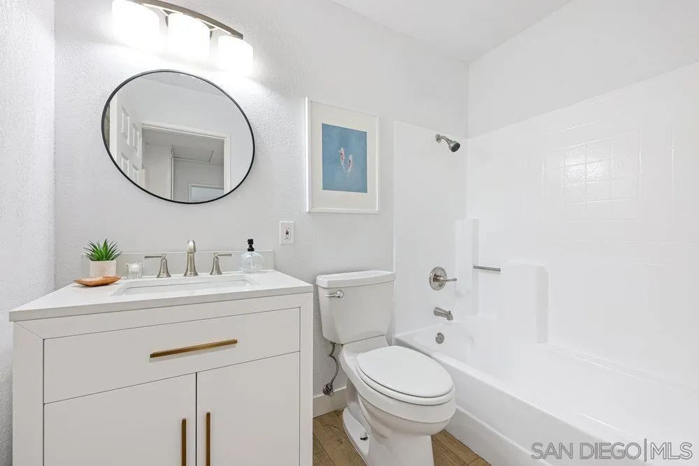 1636 Arabian Way Oceanside, CA 92057 - Photo 14 of 21 a bathroom with a sink a toilet and a mirror