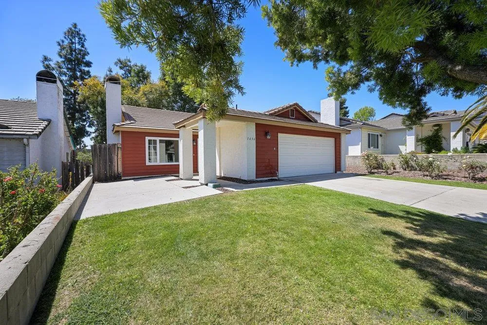 1636 Arabian Way Oceanside, CA 92057 - Photo 2 of 21 a front view of a house with a garden and yard