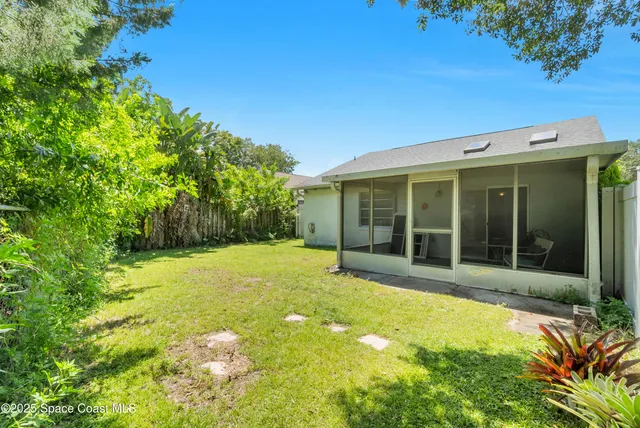 a view of a large trees with garden in front of it
