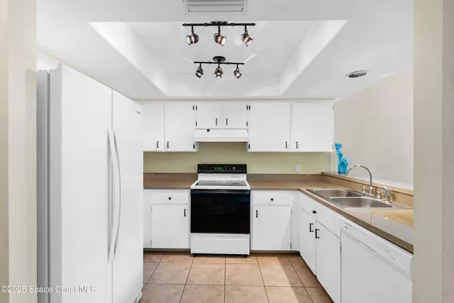 a kitchen with stainless steel appliances a stove sink and cabinets