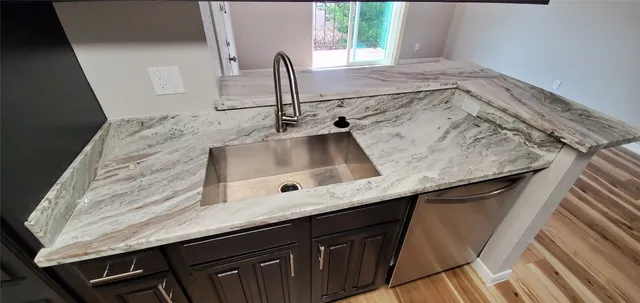 a view of a room with wooden floor and window